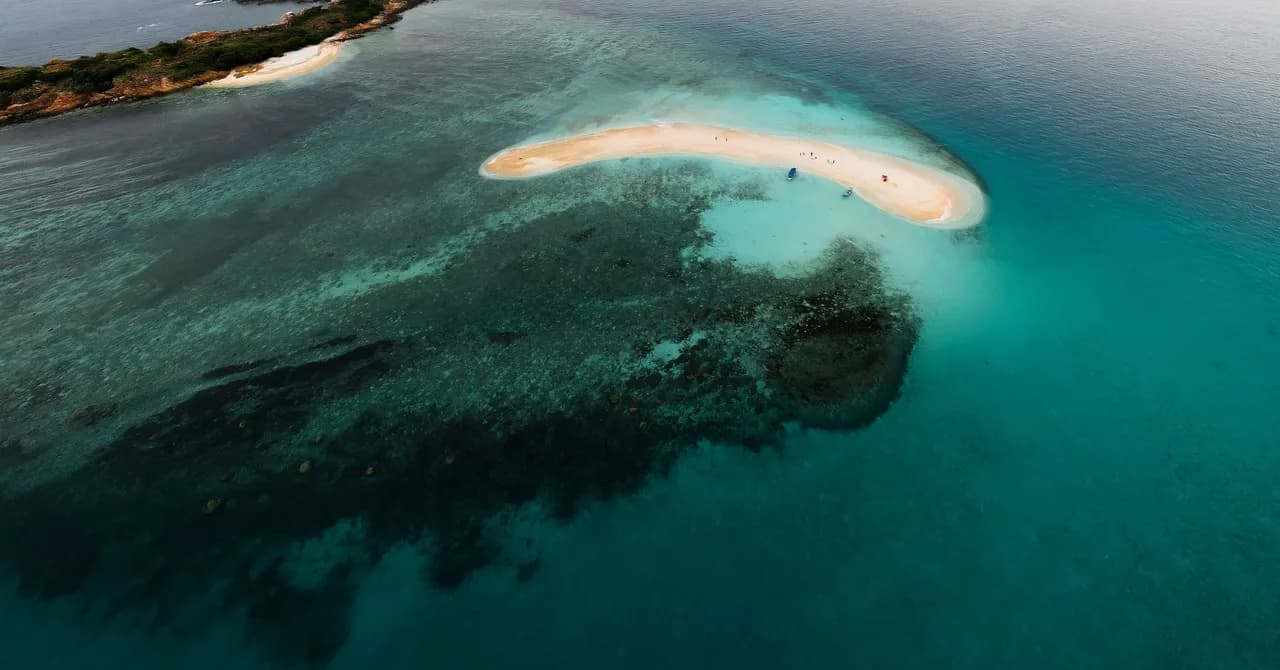 An aerial view of a sandy cay and coral reef in the Los Roques archipelago, Venezuela