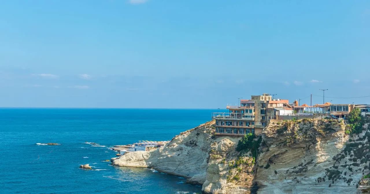 Cliffside cafés and buildings above the turquoise Mediterranean coastline near Beirut, Lebanon