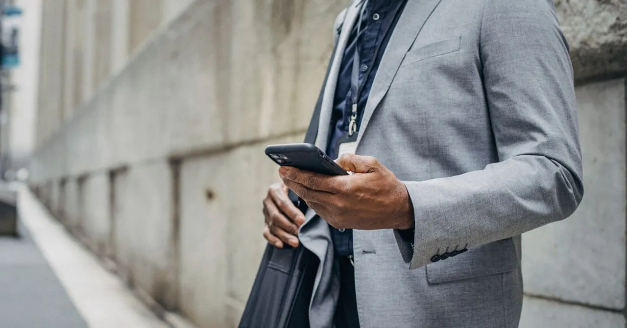 A traveler checking their smartphone's network settings screen while out in a city