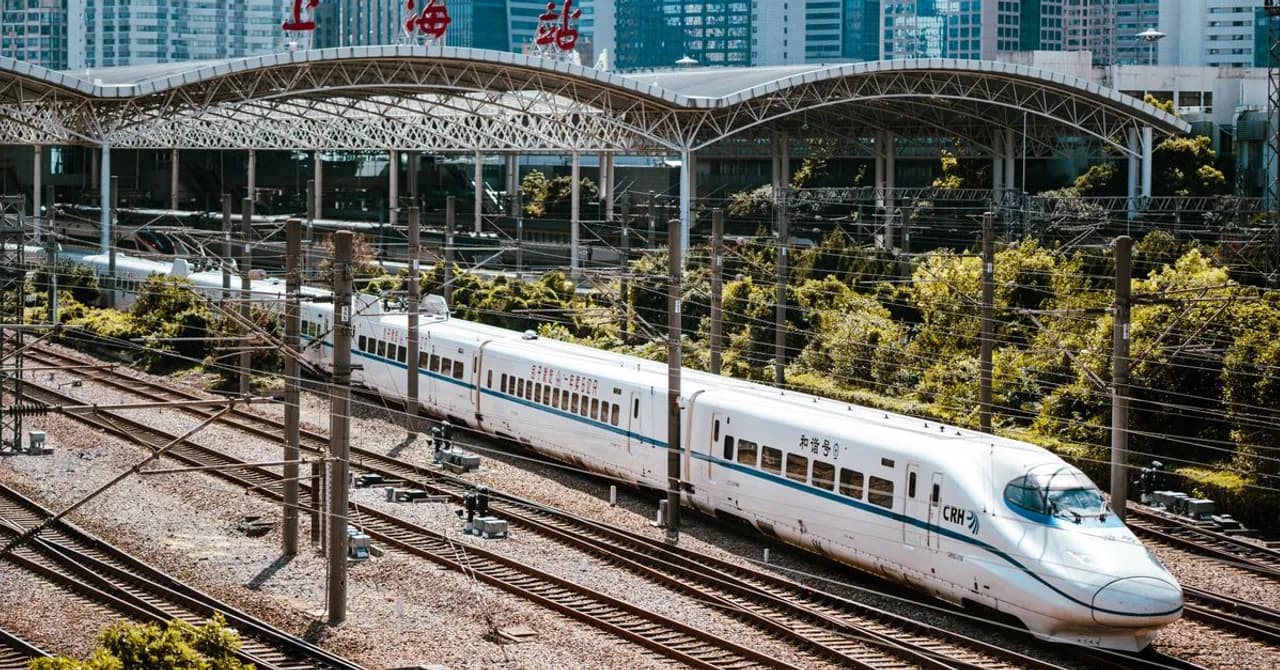 A high-speed train at a platform in a modern Chinese railway station