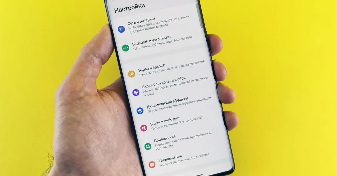 Close-up of a hand holding a smartphone open to its network settings menu