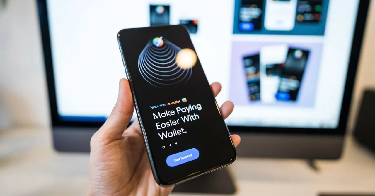 A close-up of a hand holding a smartphone open to an account and payment app