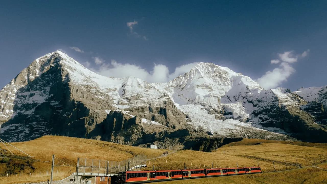 A train winding through the snow-capped Swiss Alps