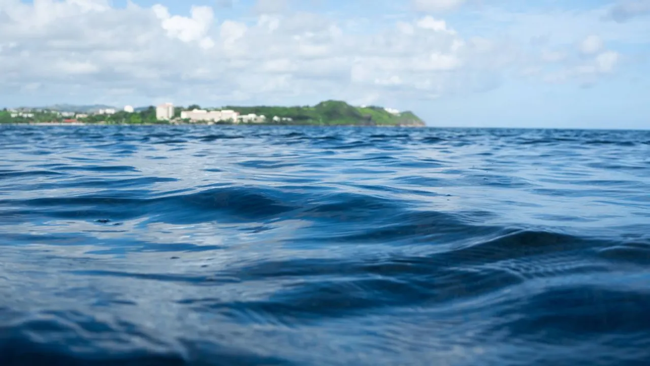 Tumon Bay's hotel strip and a green headland seen from the water in Guam