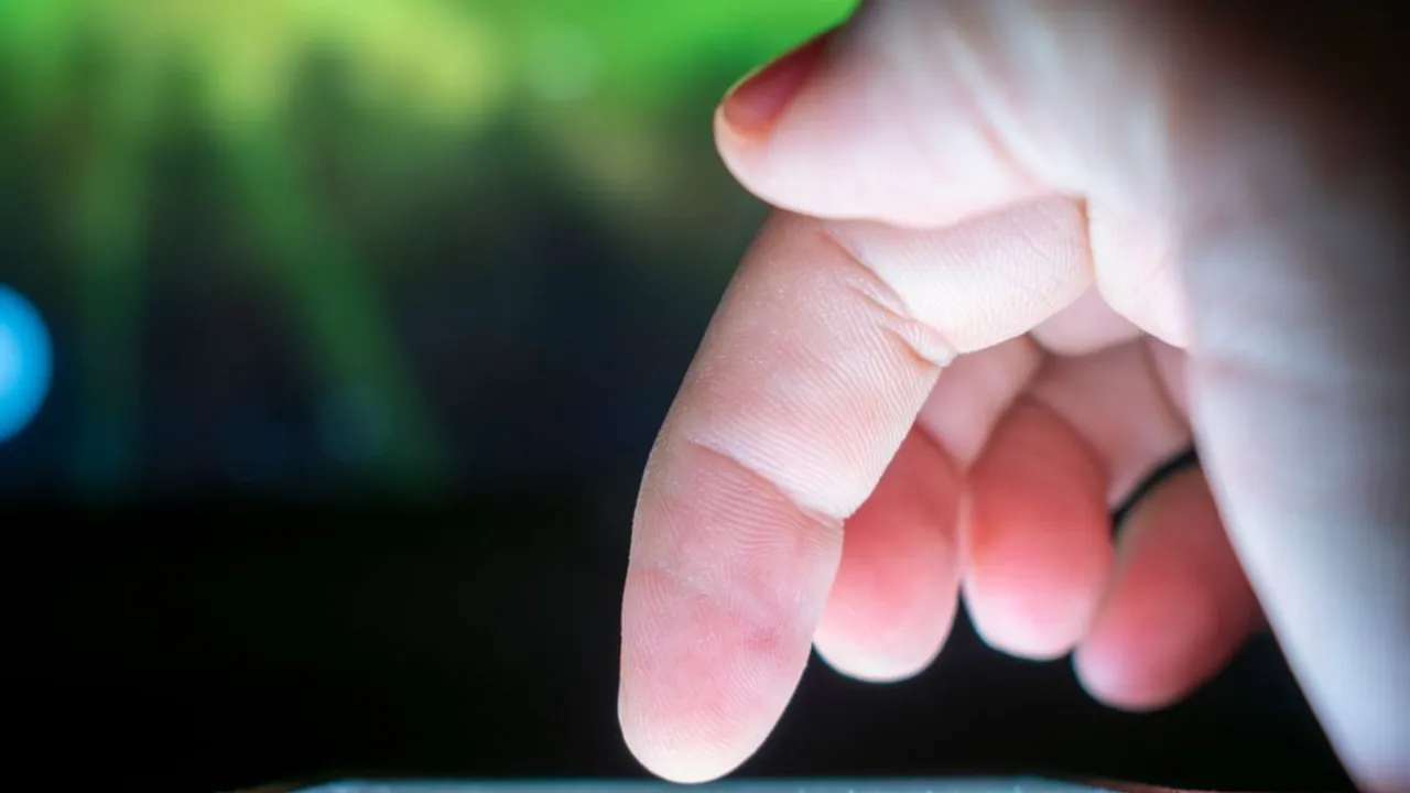Close-up of a finger tapping a smartphone touchscreen