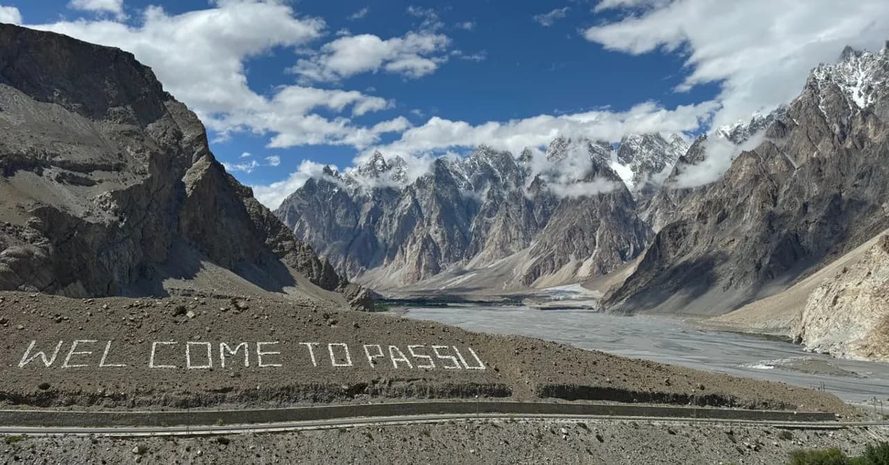 The jagged Passu Cones peaks rising above the Karakoram Highway and the Hunza River near Passu, northern Pakistan