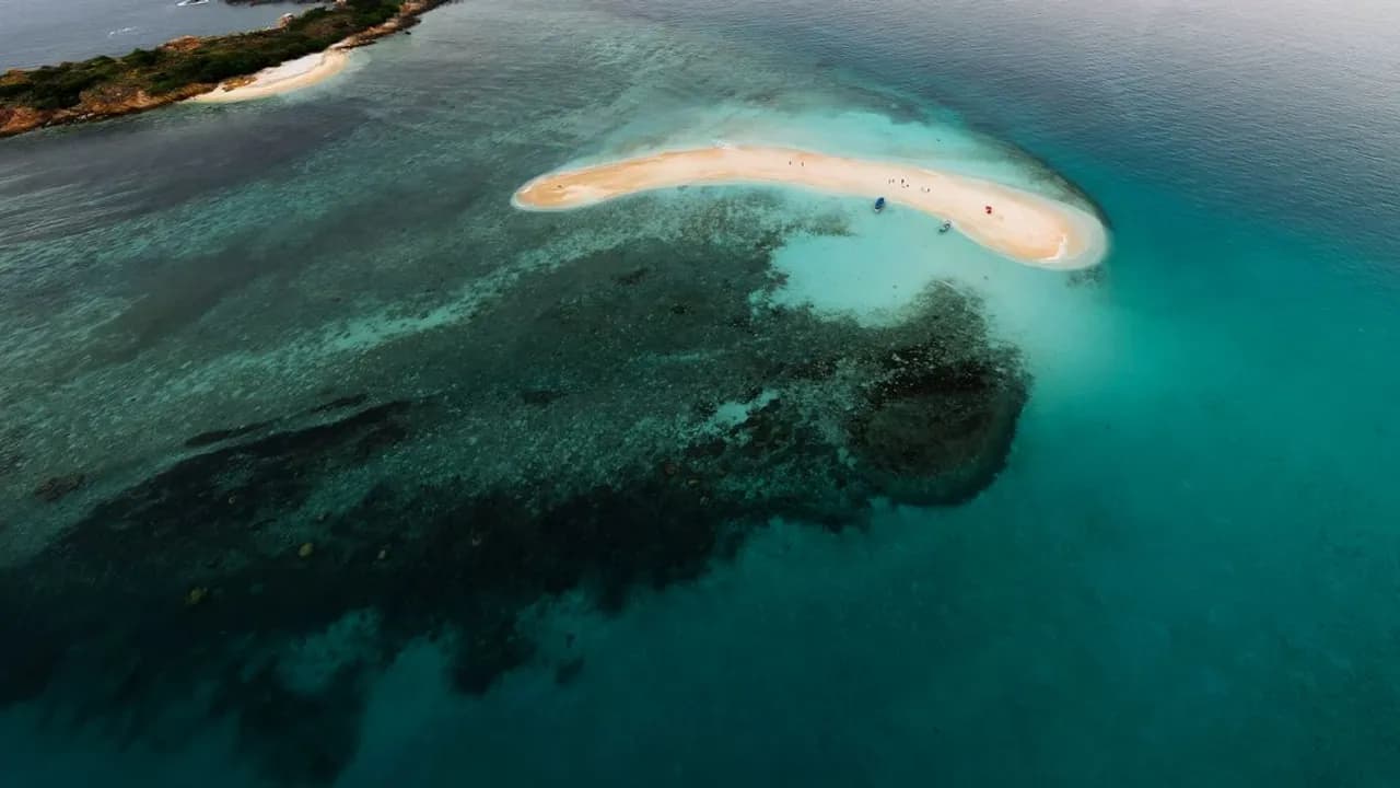 Aerial view of a secluded tropical island surrounded by turquoise water