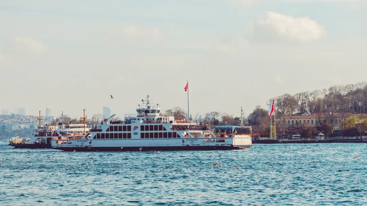 Ferries crossing the Bosphorus strait in Istanbul with the city skyline behind