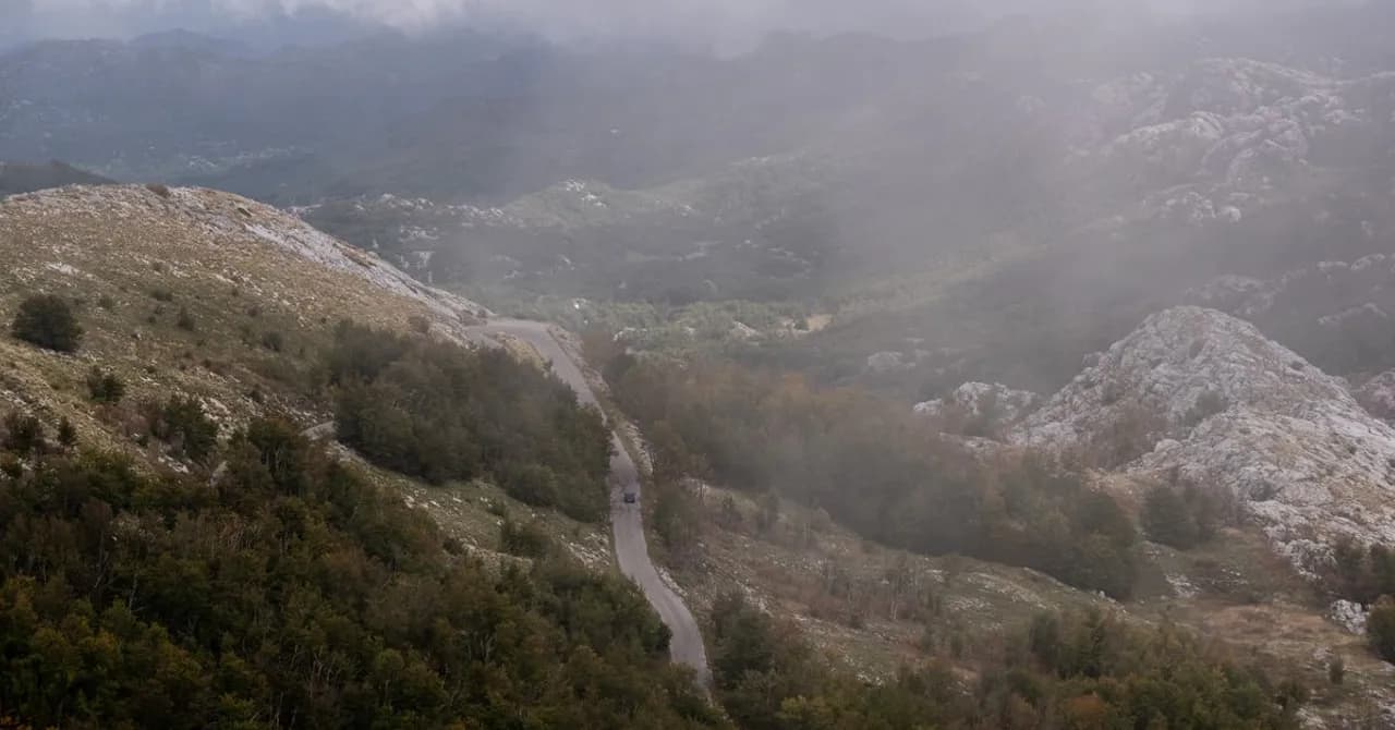 Eine Straße windet sich durch neblige Kalksteinberge im westlichen Balkan